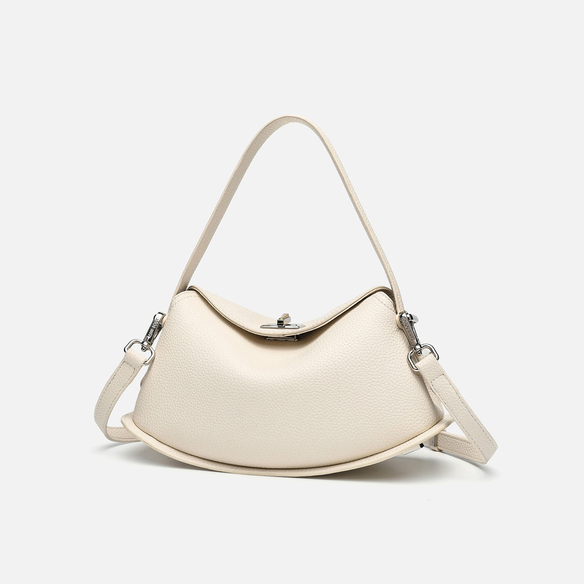 Pebbled leather-look half-moon saddle bag with turn-lock flap closure, top handle, and detachable crossbody strap, detail