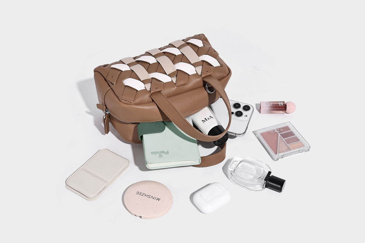 Small structured satchel bag with two-tone woven front panel, dual top handles, and detachable crossbody strap in tan brown