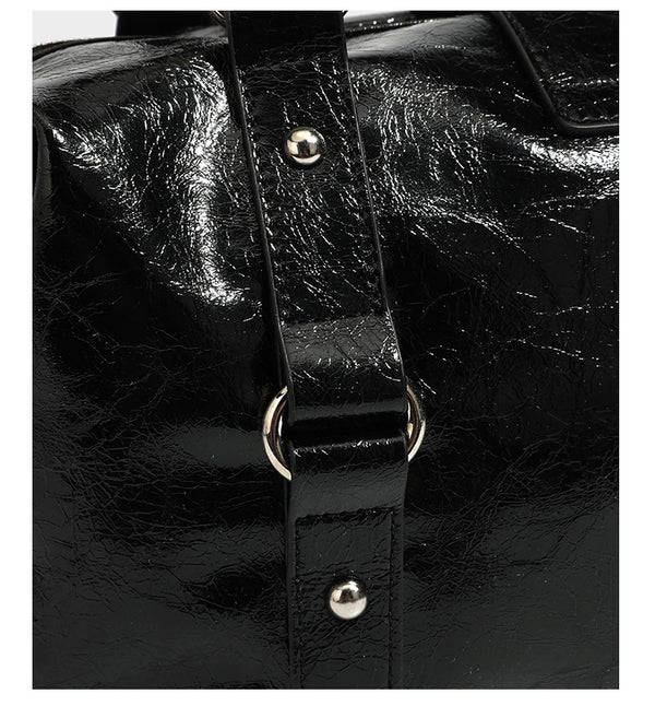 Glossy crinkled barrel handbag with silver stud buckle strap and detachable shoulder strap, detail view 17