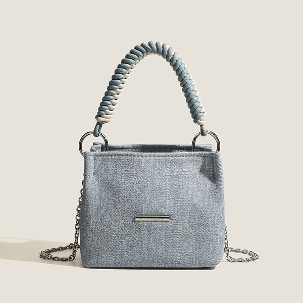 Small structured trapezoid mini bag with coiled rope top handle and silver-tone chain strap in textured fabric, detail view 6