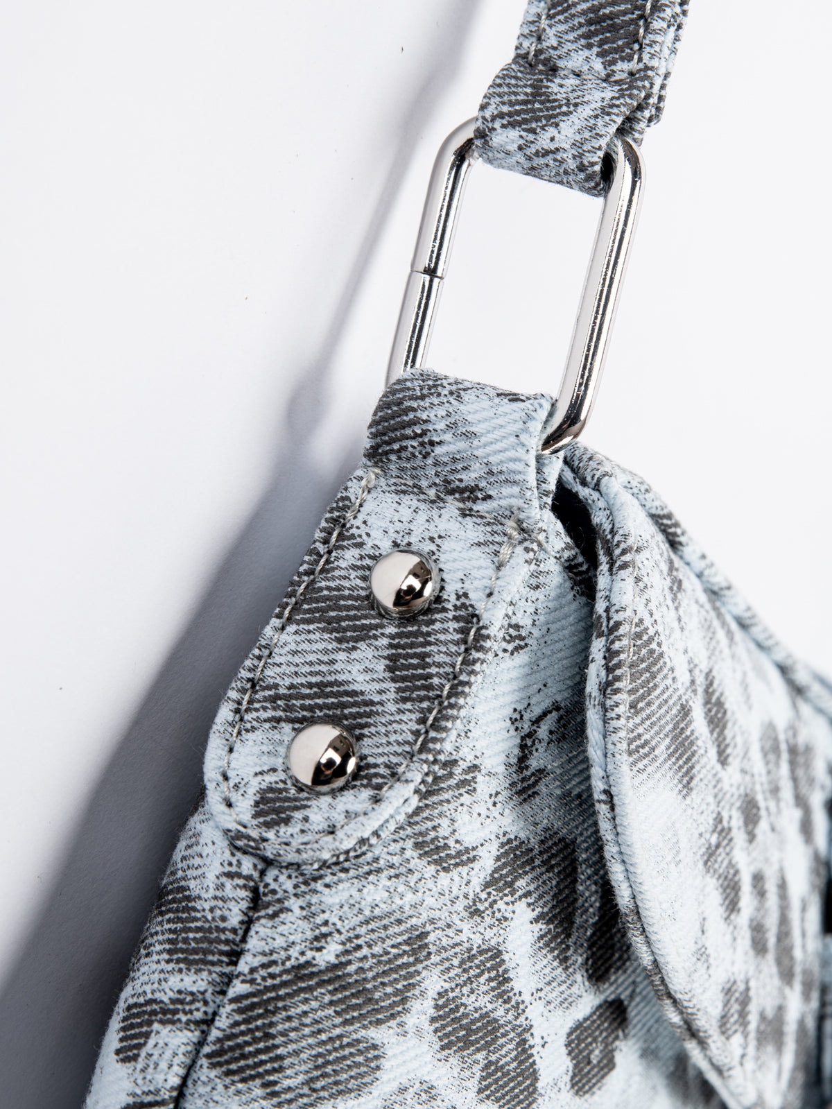 Small washed leopard print shoulder bag in blue-grey with silver buckle strap and stud accents, detail view 12
