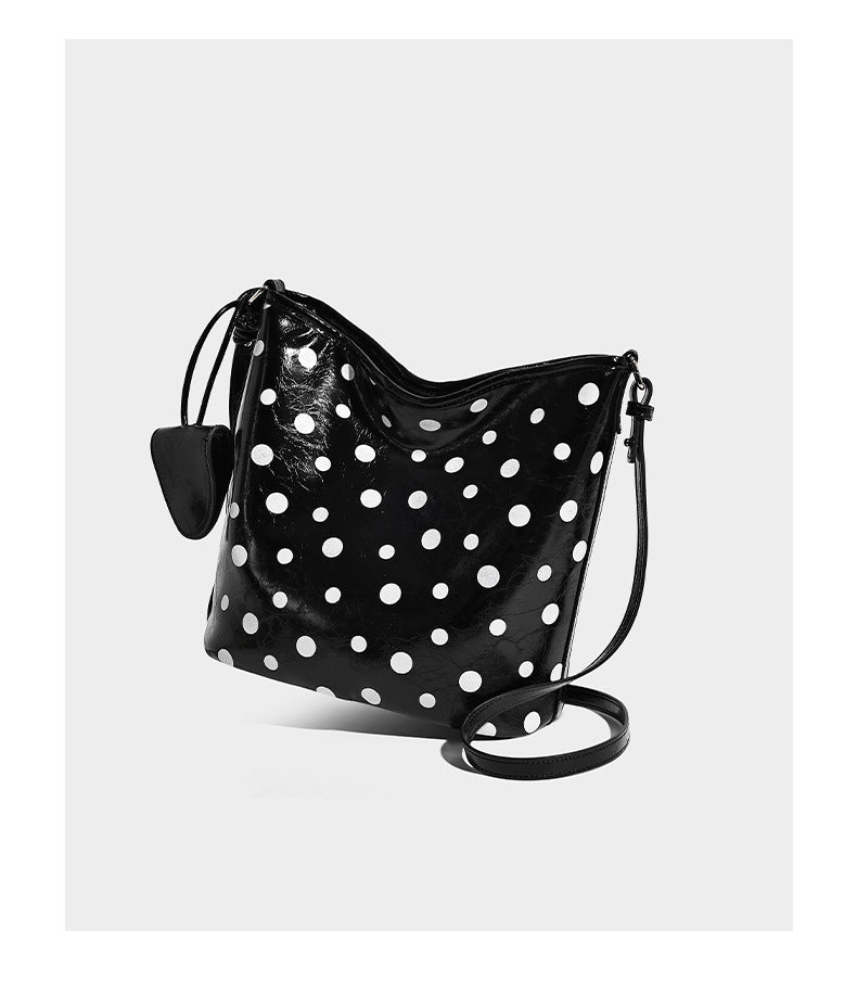 Glossy crinkled polka-dot bucket hobo bag with adjustable crossbody strap and side pouch, detail view 10