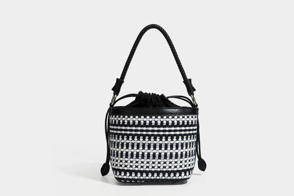 Small structured woven checker bucket bag with braided top handle, drawstring closure, and silver-tone hardware in black