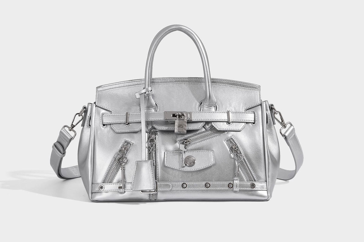 Structured black leather-look satchel bag with silver padlock hardware, front zip pockets, key charms, and top handles