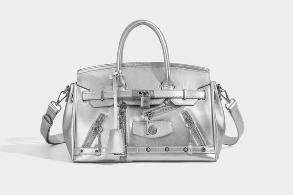 Structured black leather-look satchel bag with silver padlock hardware, front zip pockets, key charms, and top handles