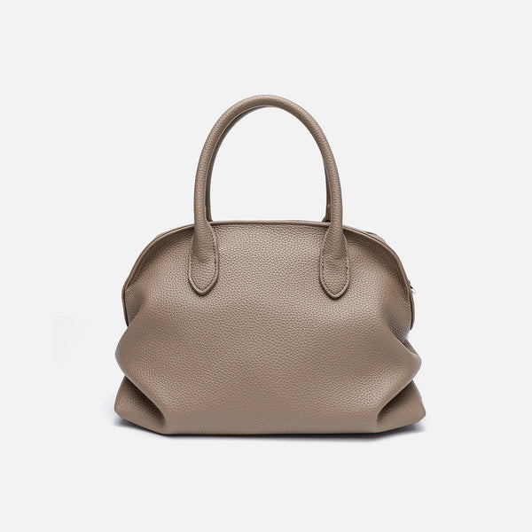 Rounded dome shell handbag in pebbled leather-look finish with twin top handles, zip closure, decorative horse charm, and