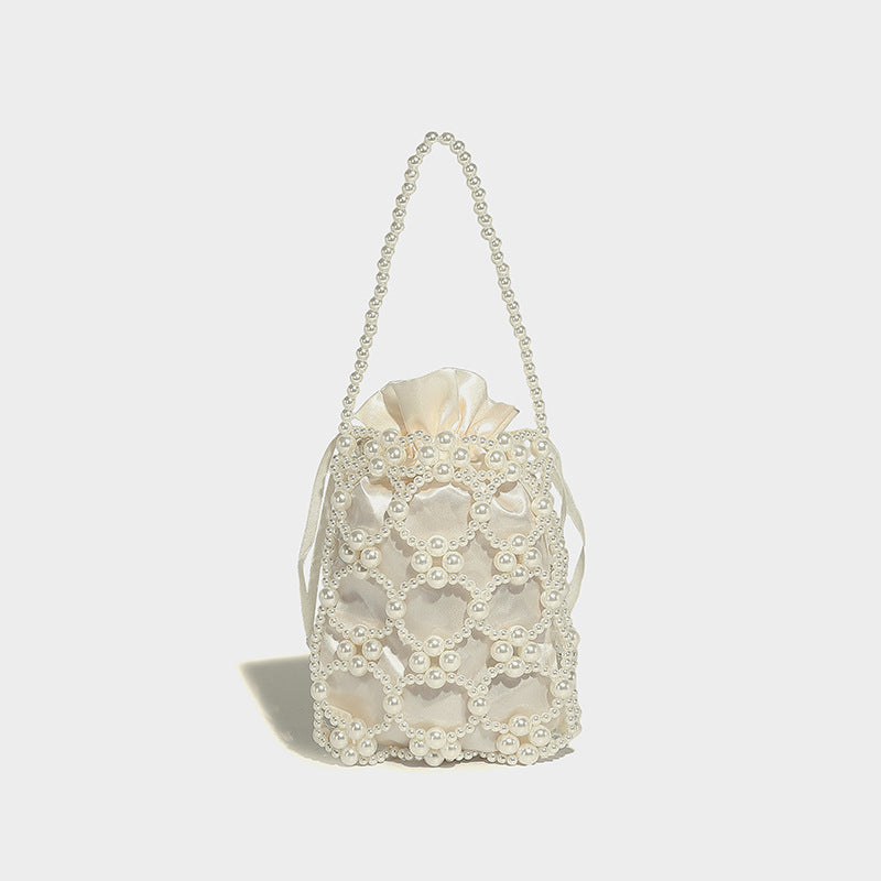 Small pearl-beaded lattice drawstring bucket bag with beaded shoulder strap and ribbon closure, detail view 19