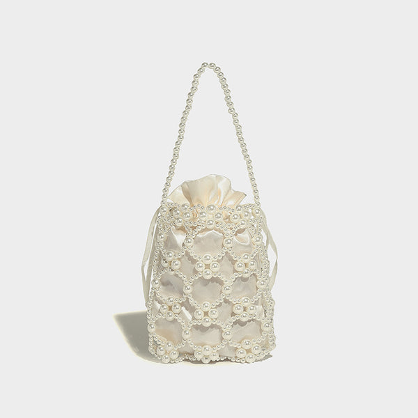 Small pearl-beaded lattice drawstring bucket bag with beaded shoulder strap and ribbon closure, detail view 19