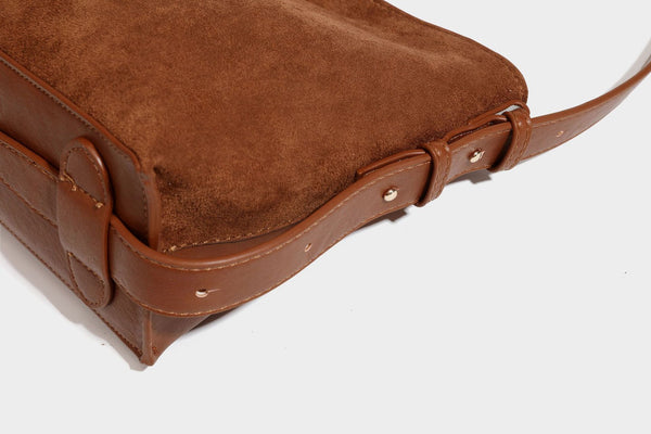 Slouchy suede-finish brown shoulder bag with long single strap and small gold-tone logo emblem on front, detail view 35