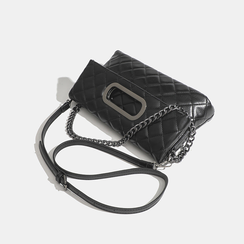 Quilted diamond-stitch flap crossbody bag with gunmetal chain strap and cut-out bar handle, detail view 3