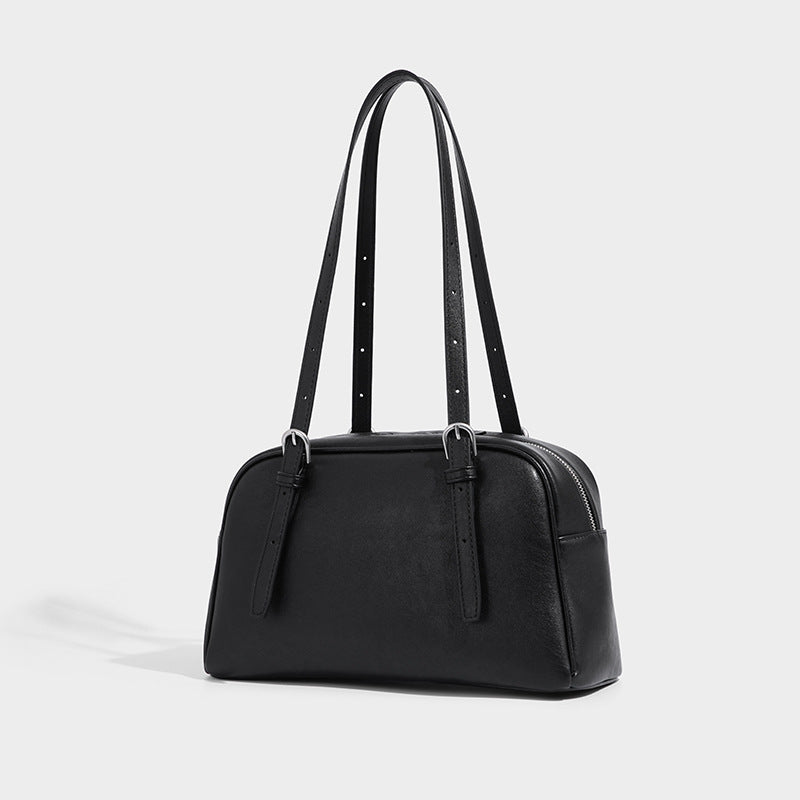 Structured dome-shaped shoulder bag with leather-look finish, top zipper closure, dual adjustable slim straps, and, detail