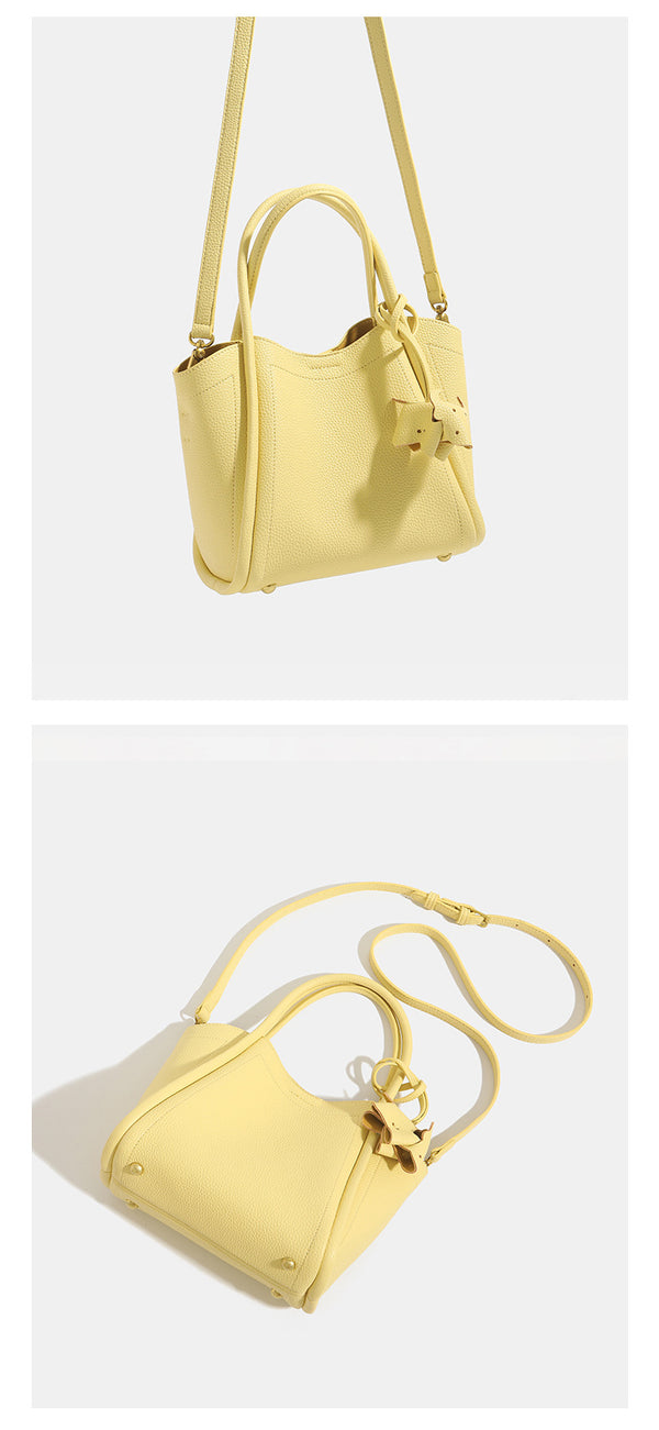 Small structured pebbled leather-look bucket tote bag with bow charm tie closure and gold-tone hardware, detail view 12