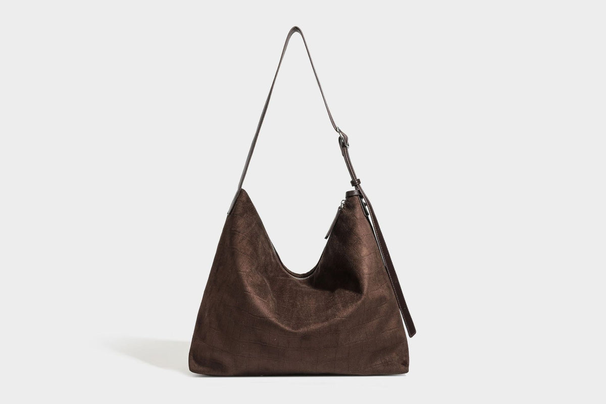 Slouchy hobo shoulder bag in matte croc-embossed leather-look finish with top zip closure and long adjustable strap, detail