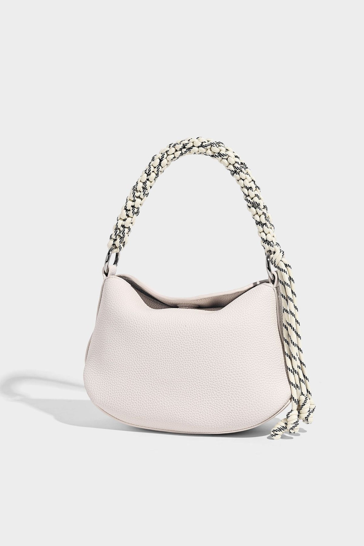 Small crescent half-moon bag in pebbled leather-look finish with braided top handle, silver-tone ring hardware, and, detail