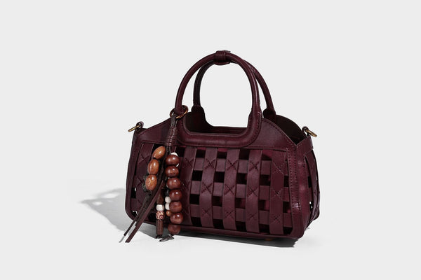 Small structured woven lattice top-handle satchel bag with bead-and-tassel charm and gold-tone hardware, detail view 32