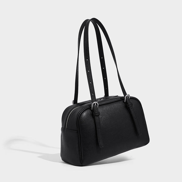 Structured dome-shaped shoulder bag with leather-look finish, top zipper closure, dual adjustable slim straps, and, front