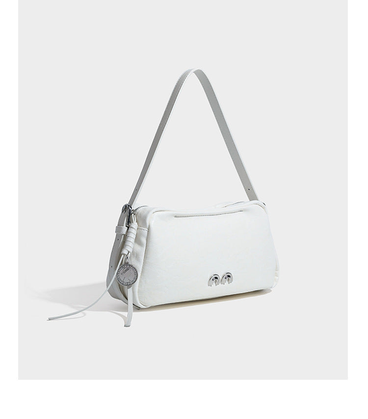 Compact black crinkled leather-look baguette shoulder bag with gold-tone arch hardware and adjustable strap, detail view 17