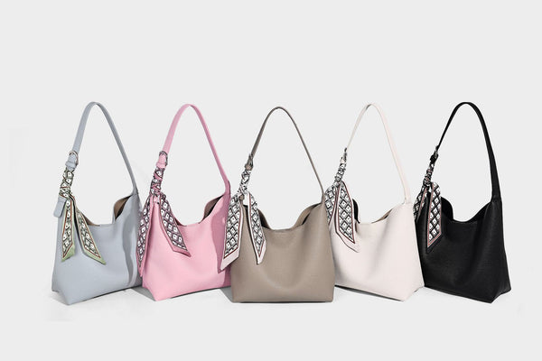 Soft slouchy hobo shoulder bag in pebbled matte finish with slim strap, silver-tone ring hardware, and knotted printed scarf