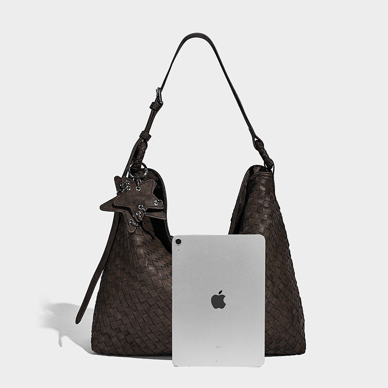 Large soft woven hobo shoulder bag with matte textured finish, adjustable strap, and star charm hardware, detail view 17