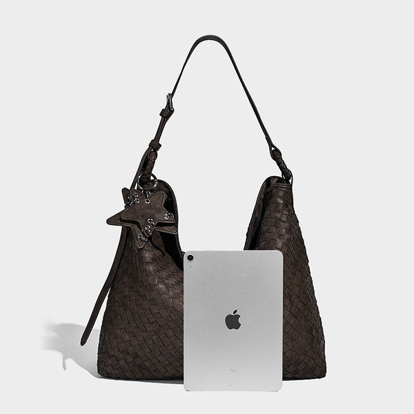Large soft woven hobo shoulder bag with matte textured finish, adjustable strap, and star charm hardware, detail view 17