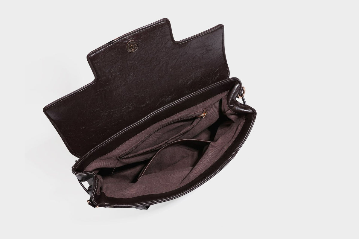 Structured glossy leather-look satchel bag with flap closure, gold-tone buckle accents, double top handles, detachable
