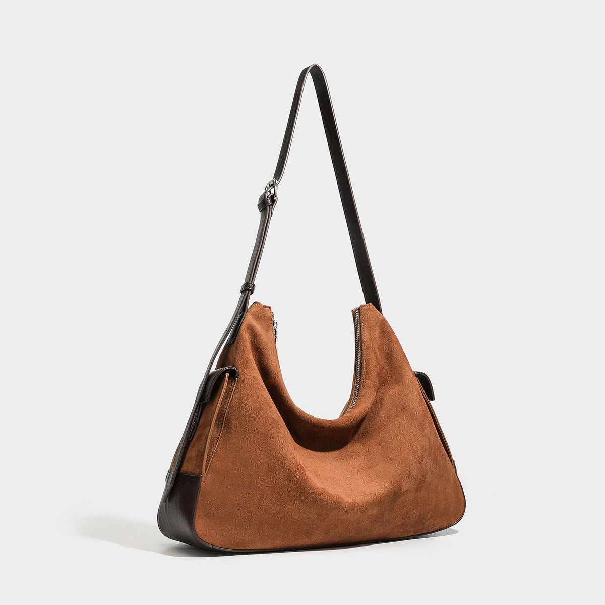 Cognac brown suede-look slouchy shoulder bag with dark brown leather-look trim, top zip closure, exterior side pocket, and