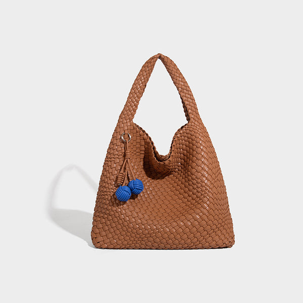 Soft hand-woven slouchy hobo tote bag with knotted tassel charm and single looped shoulder strap, detail view 12
