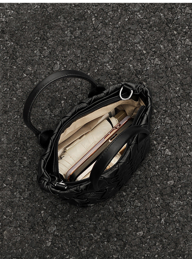 Small black glossy woven tote bag with dual top handles and detachable shoulder strap, detail view 13