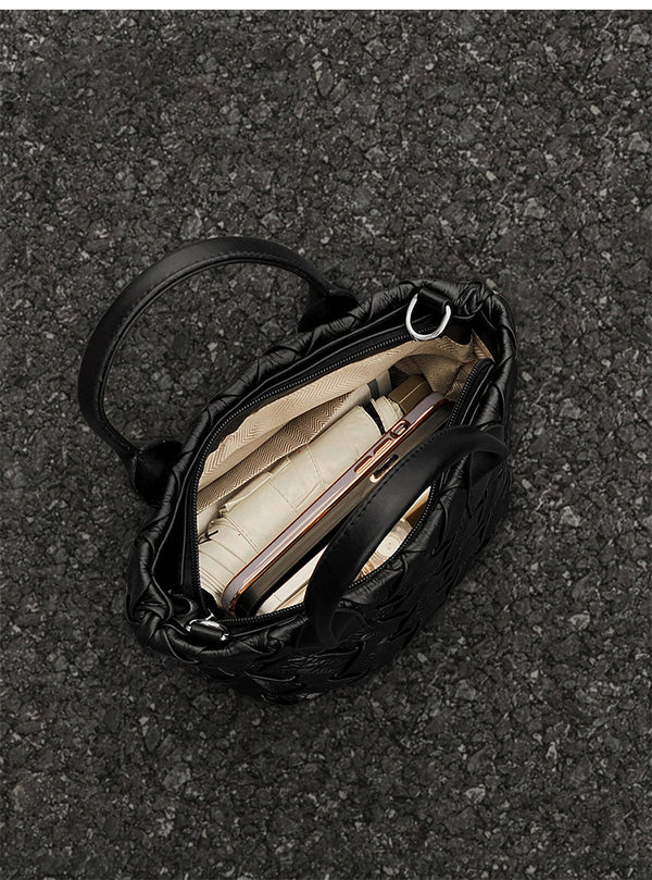 Small black glossy woven tote bag with dual top handles and detachable shoulder strap, detail view 13