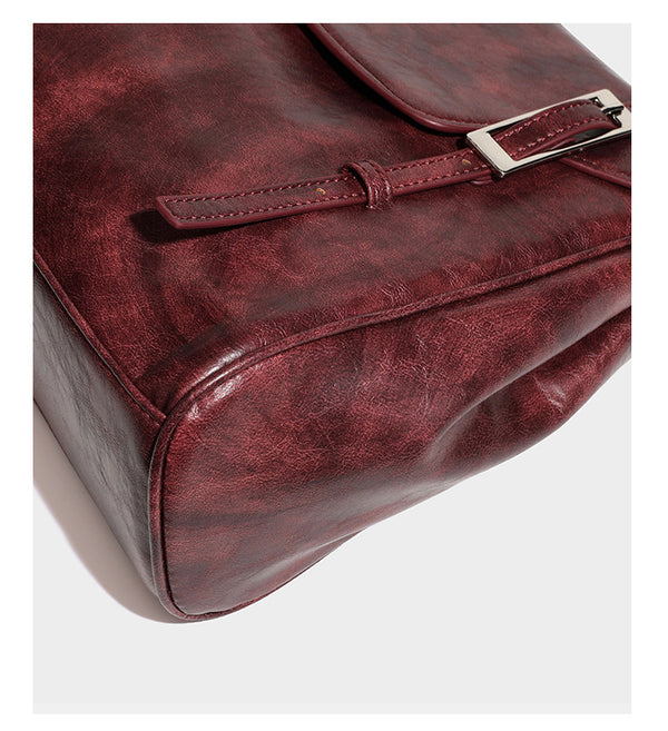 Structured flap-top shoulder tote bag in distressed leather-look finish with silver-tone buckle hardware and double shoulder