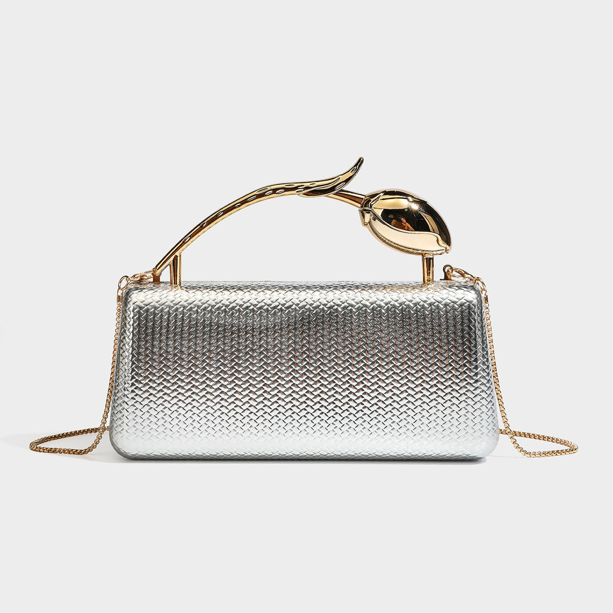 Structured rectangular metallic woven clutch bag with sculptural gold-tone leaf top handle and detachable chain strap, detail