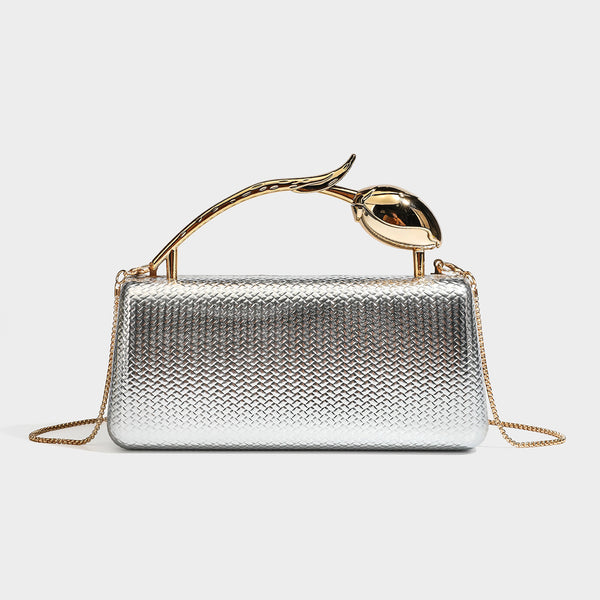 Structured rectangular metallic woven clutch bag with sculptural gold-tone leaf top handle and detachable chain strap, detail