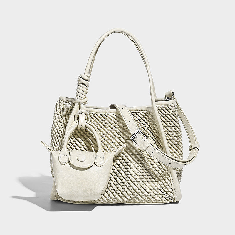 Large structured woven rope-texture tote bag with smooth leather-look trim, knotted dual top handles, detachable mini front