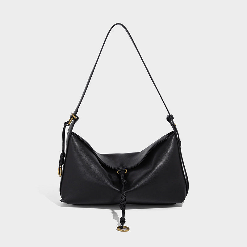 Slouchy brown leather-look shoulder bag with knotted drawcord tie closure, gold-tone ring hardware, and long adjustable