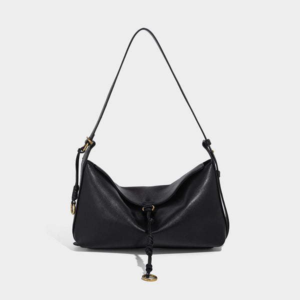 Slouchy brown leather-look shoulder bag with knotted drawcord tie closure, gold-tone ring hardware, and long adjustable