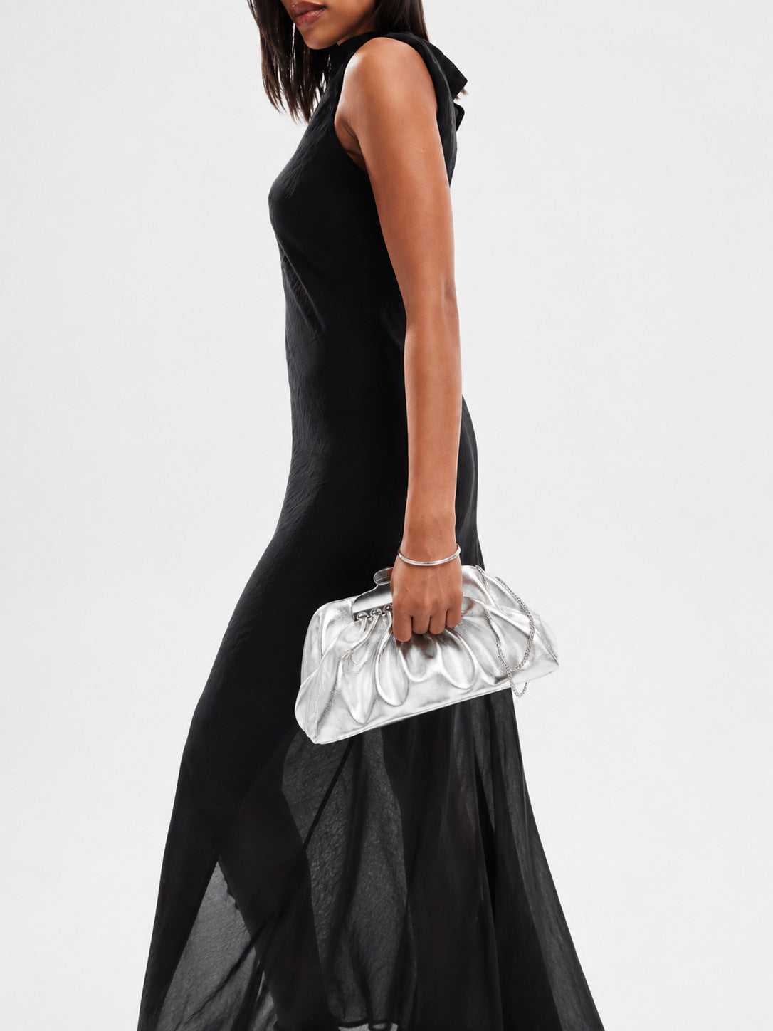 Gathered pouch clutch bag in metallic silver with polished silver-tone frame clasp and fine chain strap, detail view 16