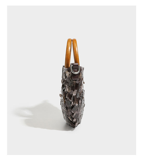Small sequin half-moon handbag with circular wood-look ring handles and detachable leather-look shoulder strap, detail view
