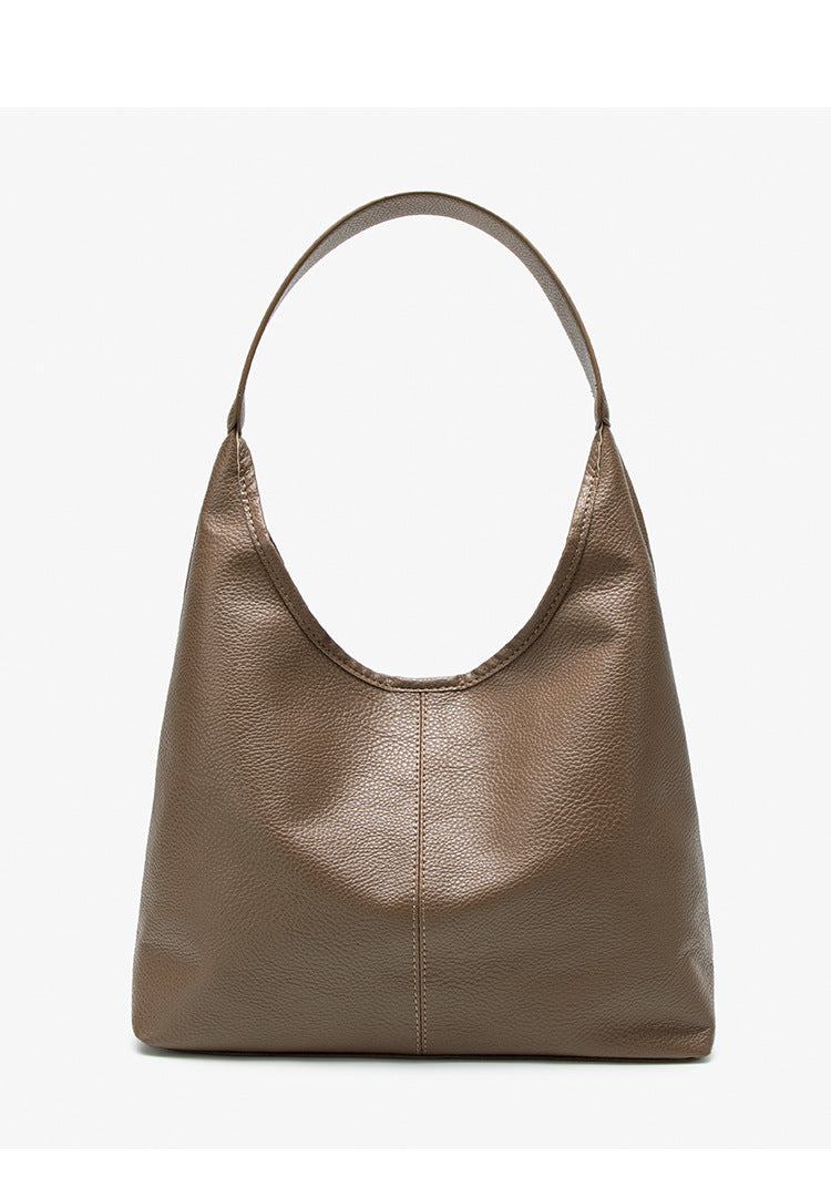 Large slouchy hobo shoulder bag in pebbled matte leather-look finish with single flat strap, detail view 14