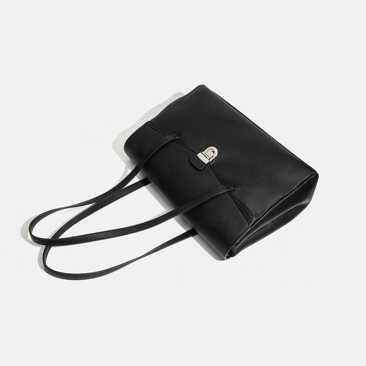 Structured black pebbled-finish flap tote bag with silver turn-lock clasp and long double shoulder straps, detail view 4