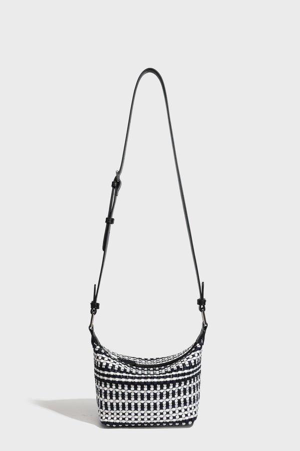 Small crescent shoulder bag in black-and-white woven textile with smooth black leather-look trim, zip-top closure, knotted
