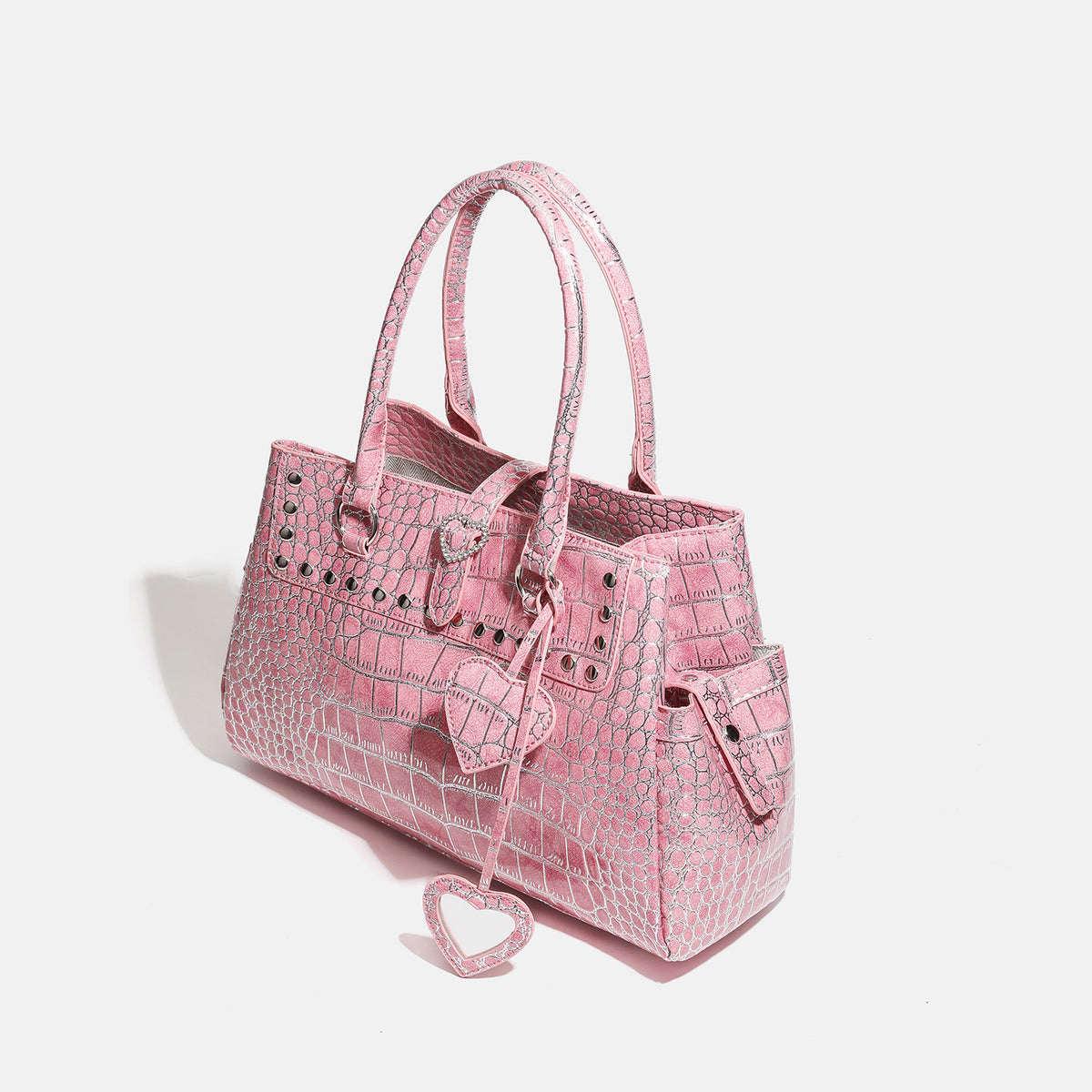 Blush pink glossy crocodile-embossed structured tote bag with studded trim, silver-tone hardware, double top handles, and