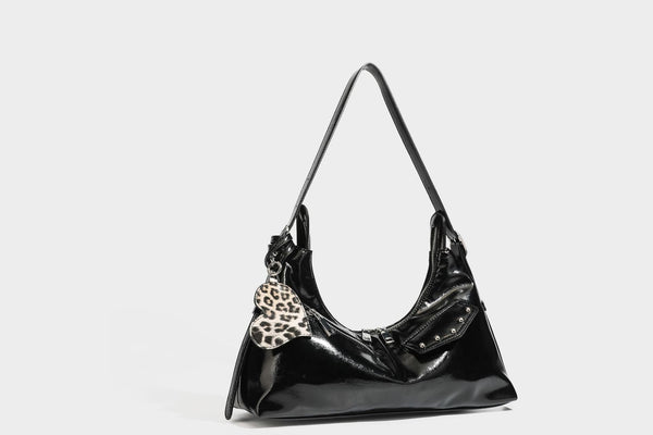 Glossy dark brown hobo shoulder bag with slim strap, front zip pocket, stud detail, and detachable leopard-print heart charm