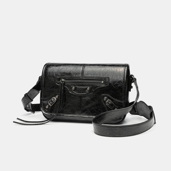 Small structured rectangular crossbody bag with crinkle leather-look finish, front zip pocket, gunmetal stud hardware, and