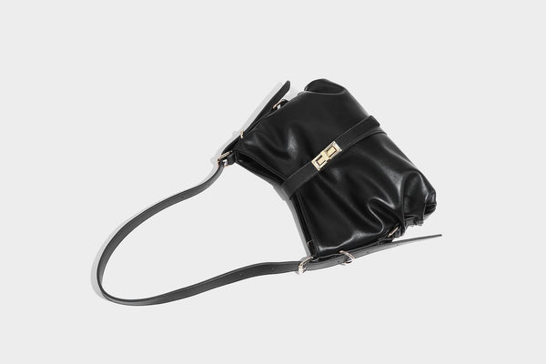 Soft slouchy hobo shoulder bag with smooth leather-look finish, gold-tone buckle and tab hardware, and long adjustable strap