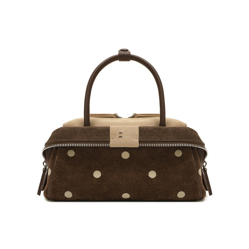 Mini structured satchel in chestnut brown with cream polka dots, curved top handles, and zip closure, detail view 2