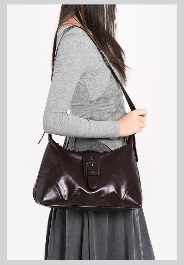 Glossy dark brown slouch hobo shoulder bag with front buckle strap panel and long adjustable single strap, detail view 21