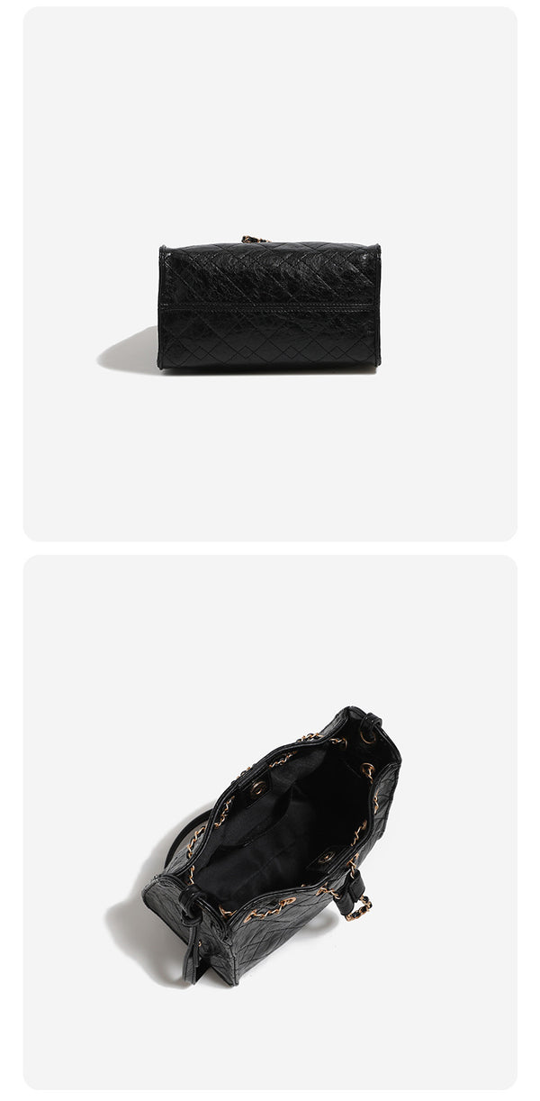 Glossy diamond-quilted drawstring bucket bag with gold-tone chain strap and eyelet hardware, detail view 16