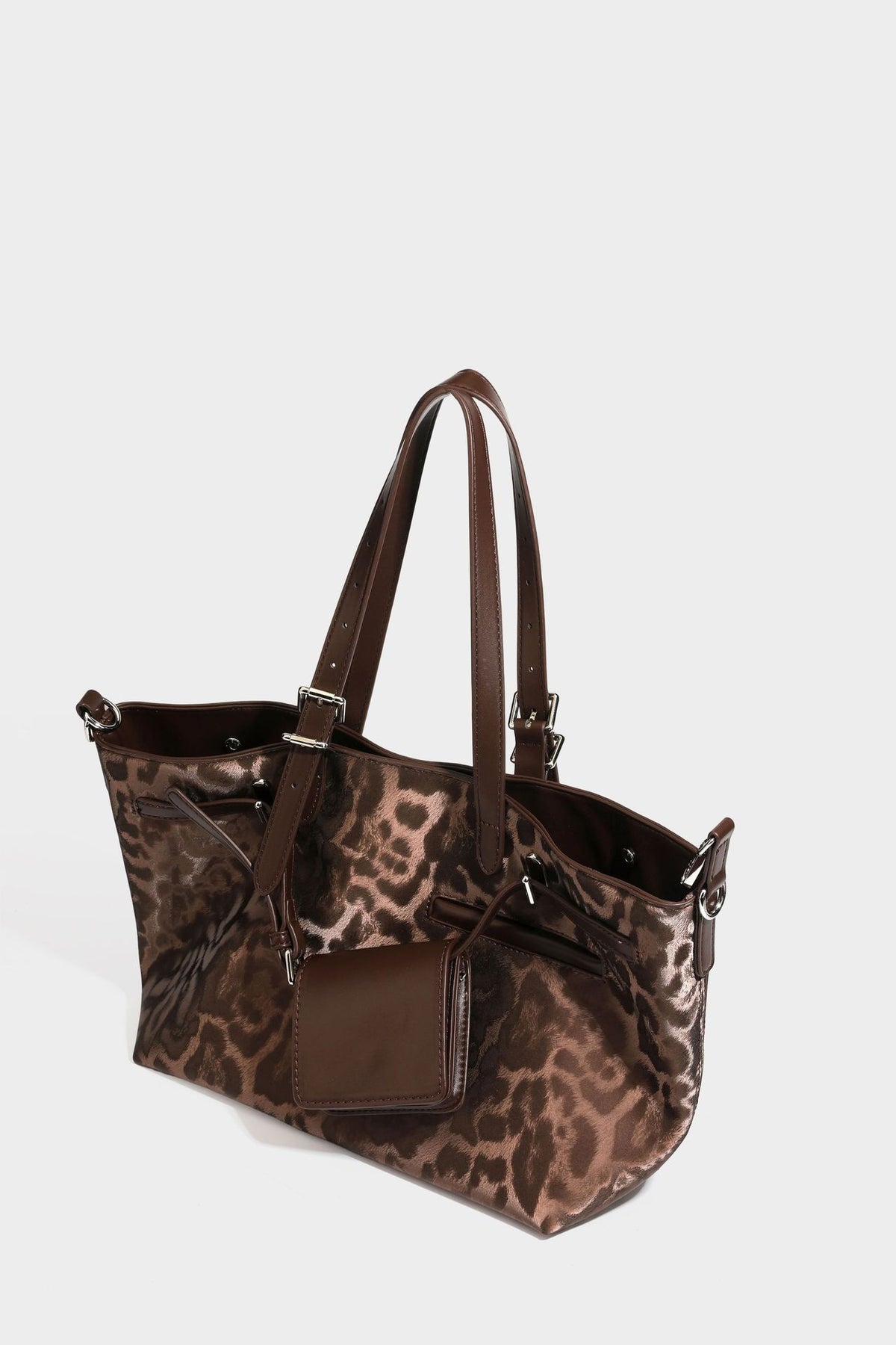 Glossy leopard-print tote bag with leather-look dark trim, dual top handles, detachable shoulder strap, and attached front