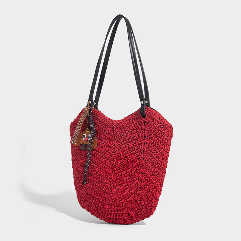 Woven crochet open-top shoulder tote bag with slim brown leather-look straps and braided charm accent, detail view 6