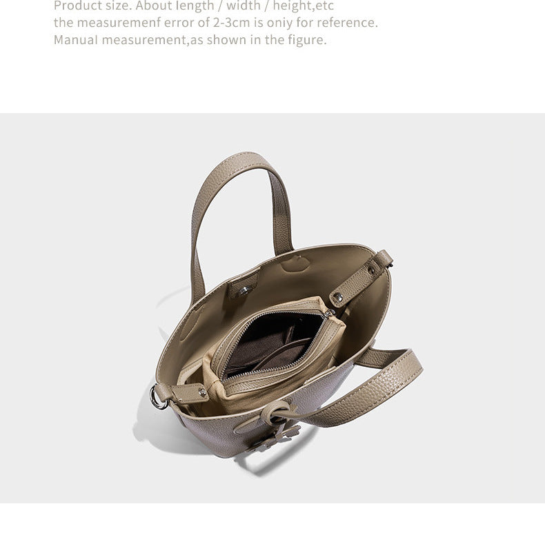 Compact pebbled bucket tote bag with elephant charm, twin top handles, and detachable crossbody strap, detail view 8